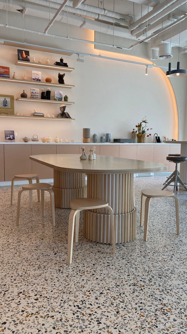 Made by Plyconcept: a custom table with a rounded top on fluted birch plywood pedestals