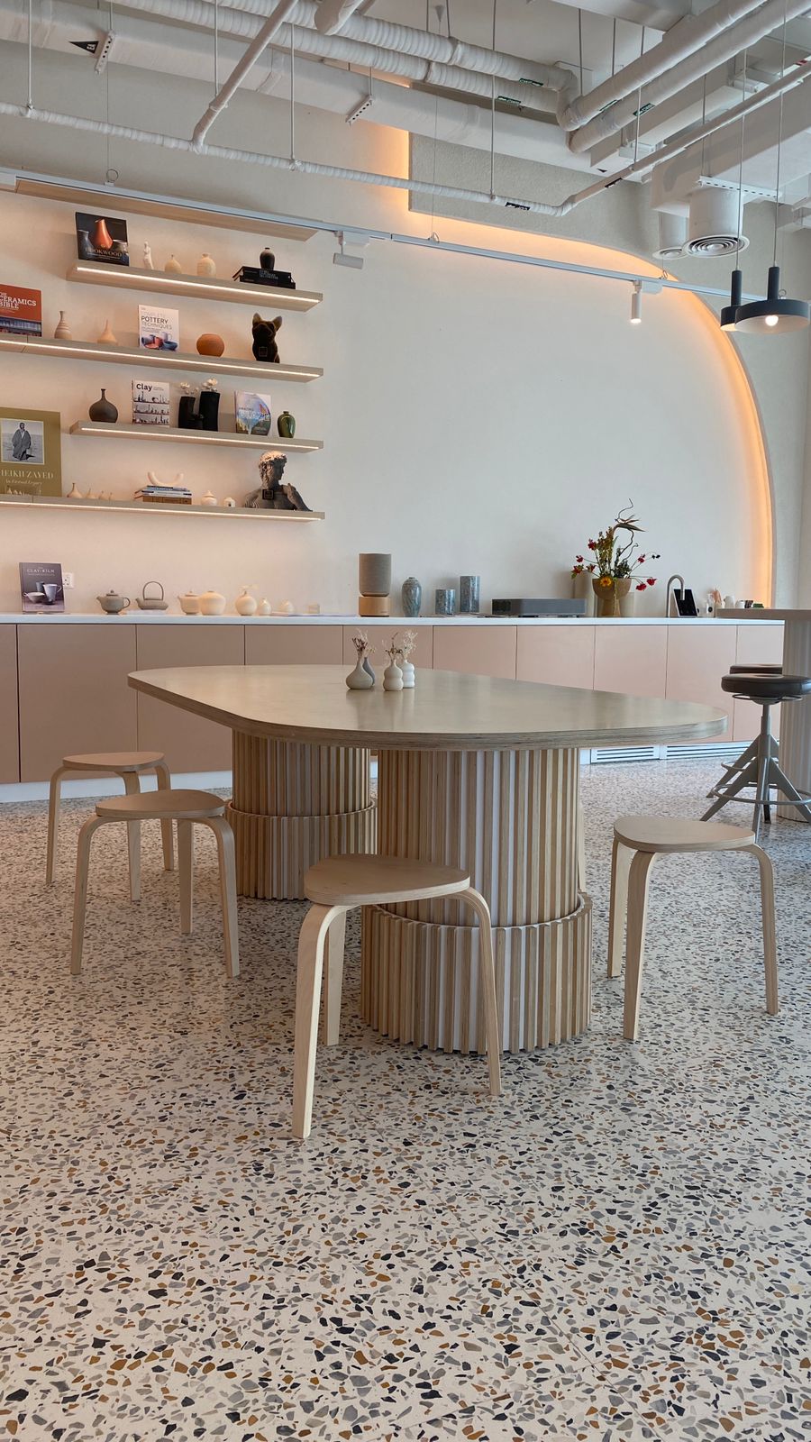 Made by Plyconcept: a custom table with a rounded top on fluted birch plywood pedestals