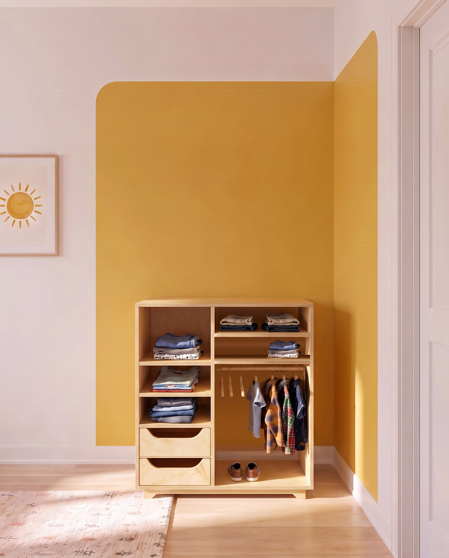 Render: the Sofi children's wardrobe in Natural birch plywood against a mustard panel, with small clothes on the rail