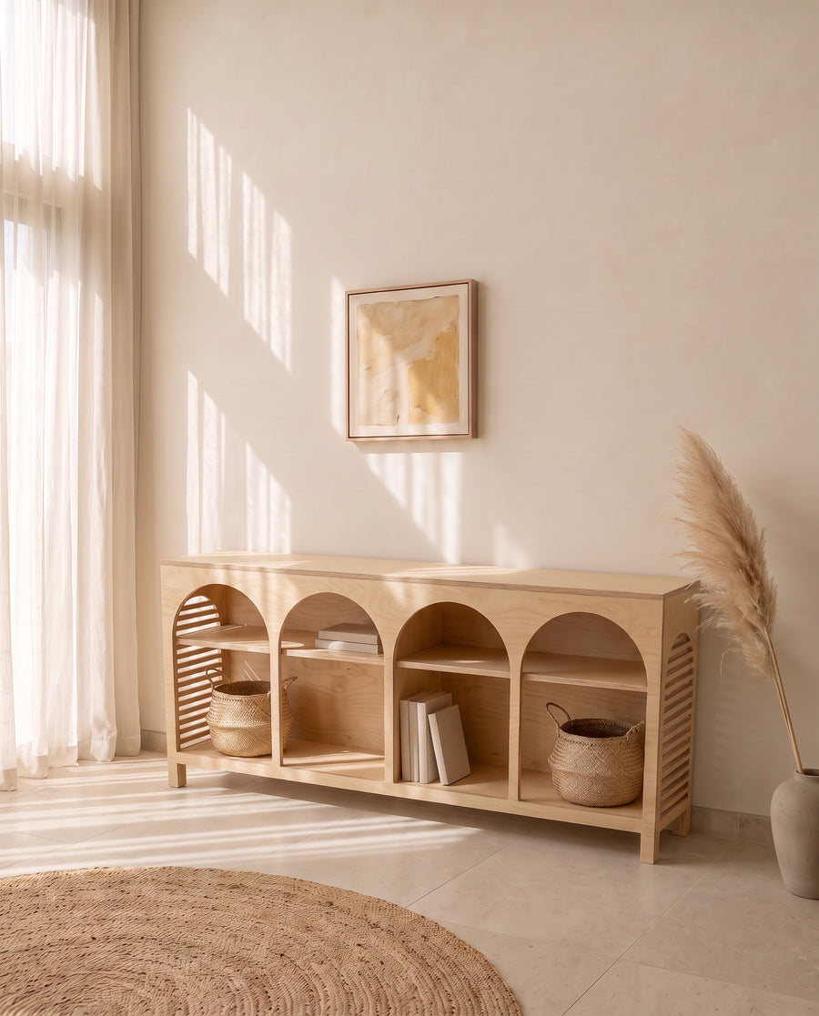 Render: the Jeffrey Lungo sideboard in Natural birch plywood, four open arches, at the dining end of a limewashed villa
