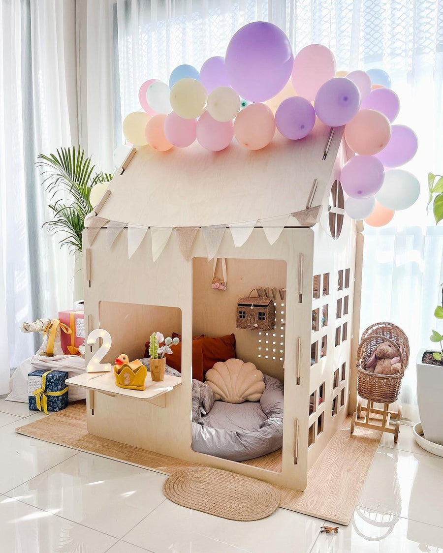 Ply House, a birch plywood children's play house, dressed with balloons for a birthday