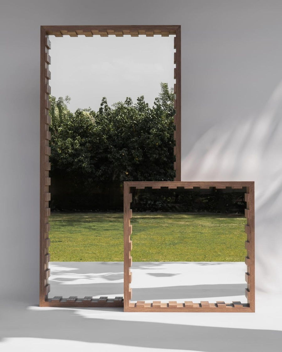 Sarab Mirror, a handmade mirror framed in oak plywood, leaning against a white wall